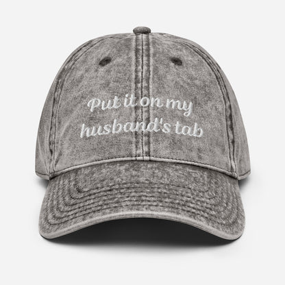 Vintage denim dad hat with &quot;Put it on my husband&#39;s tab&quot; embroidery. Funny, sarcastic, and perfect for gifts. Great for vintage style and versatile wear.