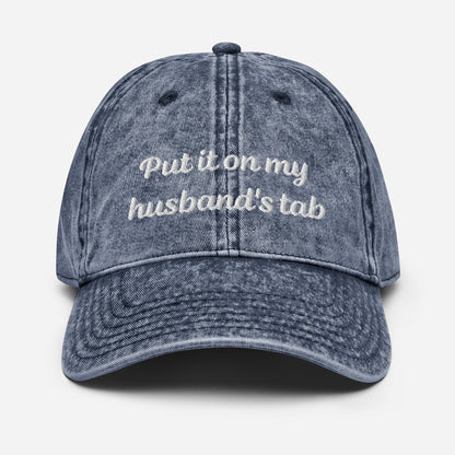 Vintage denim dad hat with &quot;Put it on my husband&#39;s tab&quot; embroidery. Funny, sarcastic, and perfect for gifts. Great for vintage style and versatile wear.