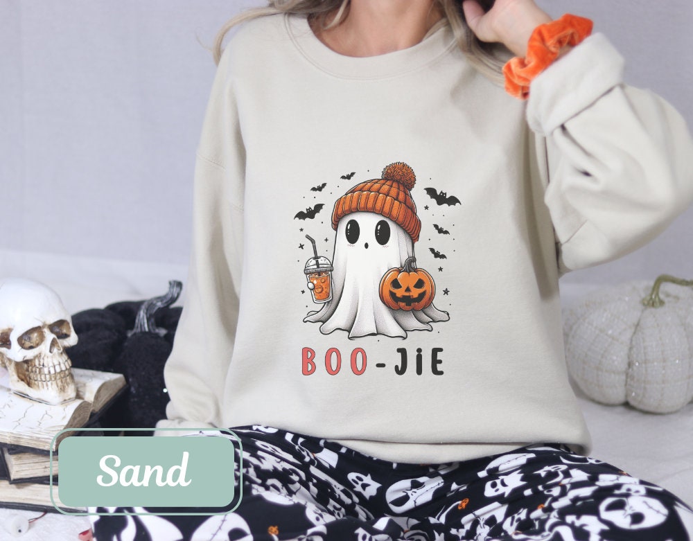 Boojee Halloween sweatshirt in sand color with a cute ghost holding a pumpkin and drink. Perfect for women, teachers, and moms. Ideal fall sweatshirt, spooky shirt, and cool Halloween shirt for Halloween party or happy Halloween gift.