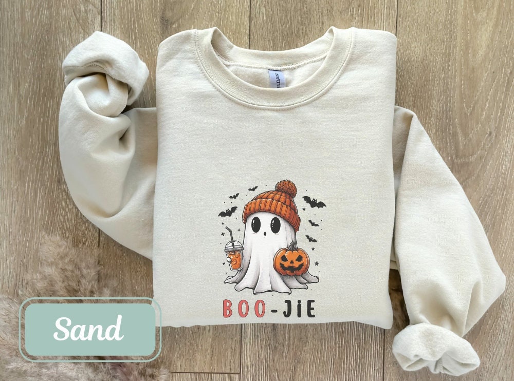 Sand-colored Boojee Halloween sweatshirt with a cute ghost holding a pumpkin and drink. Ideal for women, teachers, and moms. Perfect fall sweatshirt, spooky shirt, and cool Halloween shirt for Halloween party or happy Halloween gift.