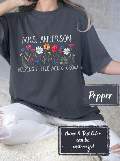 Teacher shirt in Pepper, tailored for classroom heroes. Features &#39;Helping Little Minds Grow&#39; with customizable text options, making it a perfect gift for first-grade and kindergarten teachers.