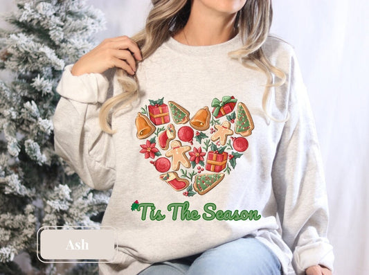 Ash gray Christmas sweatshirt showcasing a delightful array of holiday treats and decorations, making it the perfect Xmas shirt for cookie lovers and those celebrating the season. Ideal for wearing as a merry and bright winter shirt.