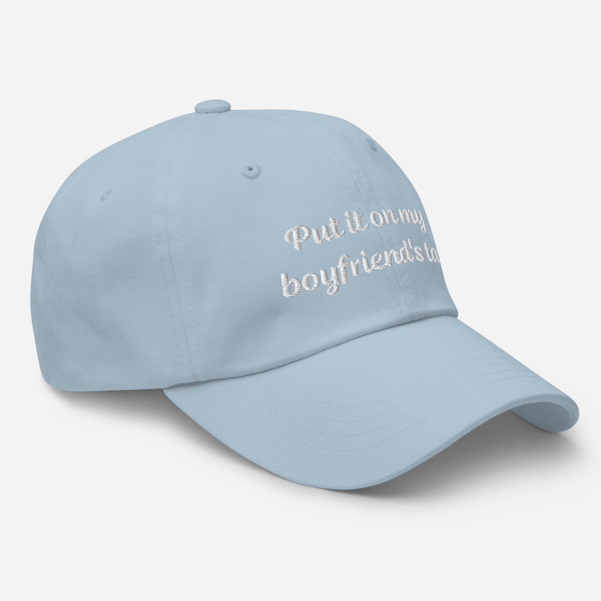 A stylish light blue dad hat with embroidered text, &quot;Put it on my boyfriend&#39;s tab,&quot; perfect as a funny gift for your girlfriend. This sarcasm-infused baseball cap adds an aesthetic touch to any outfit.