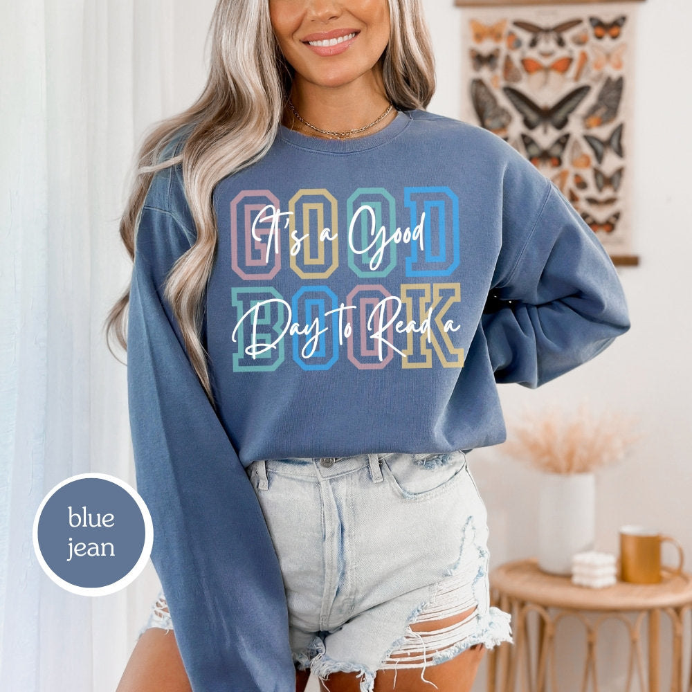 Comfort Colors sweatshirt in blue jean with &#39;It’s a Good Day to Read a Book&#39; design. Ideal for book lovers, teachers, and book clubs. Perfect for trendy literary shirts and teacher appreciation gifts.