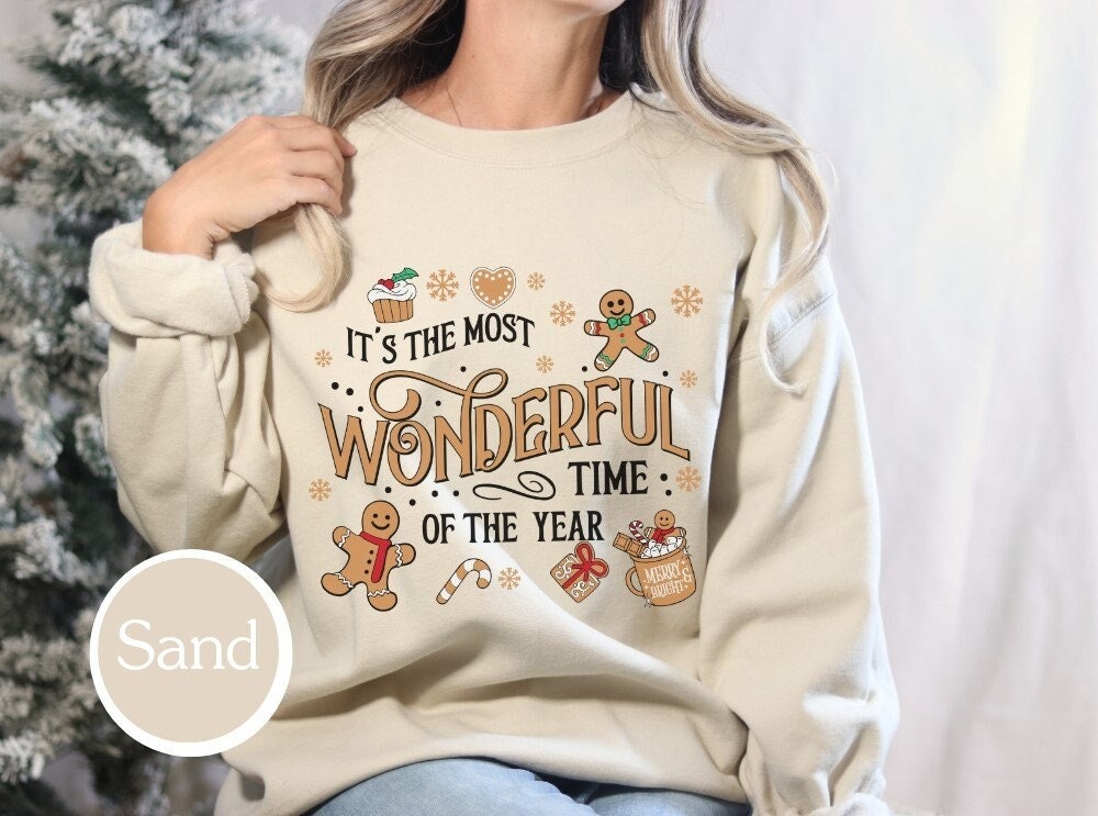 Soft Sand-colored holiday sweatshirt with &quot;It&#39;s the Most Wonderful Time of the Year&quot; design, ideal for Christmas gifts, xmas shirt lovers, and family Christmas outfits.