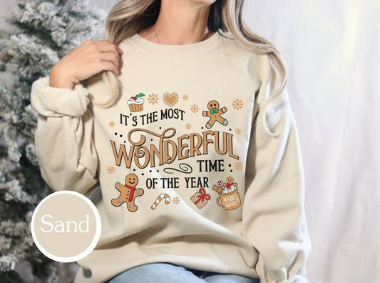 Soft Sand-colored holiday sweatshirt with &quot;It&#39;s the Most Wonderful Time of the Year&quot; design, ideal for Christmas gifts, xmas shirt lovers, and family Christmas outfits.