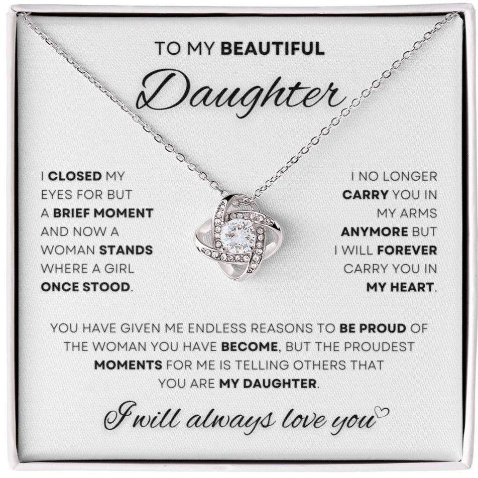 Silver Love Knot Necklace with a sparkling cubic zirconia, presented in a box with a touching message from a parent to a daughter, celebrating her growth and everlasting love.