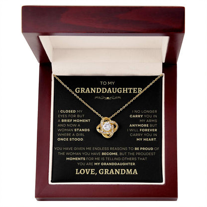Gold Loveknot necklace in a luxurious mahogany box with heartfelt message to granddaughter from grandma, an elegant and meaningful gift.