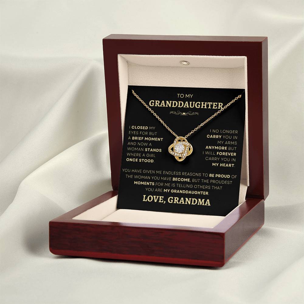 Elegant gold-plated Loveknot necklace presented in a mahogany gift box with a touching message from grandmother to granddaughter, capturing the essence of family love and legacy.
